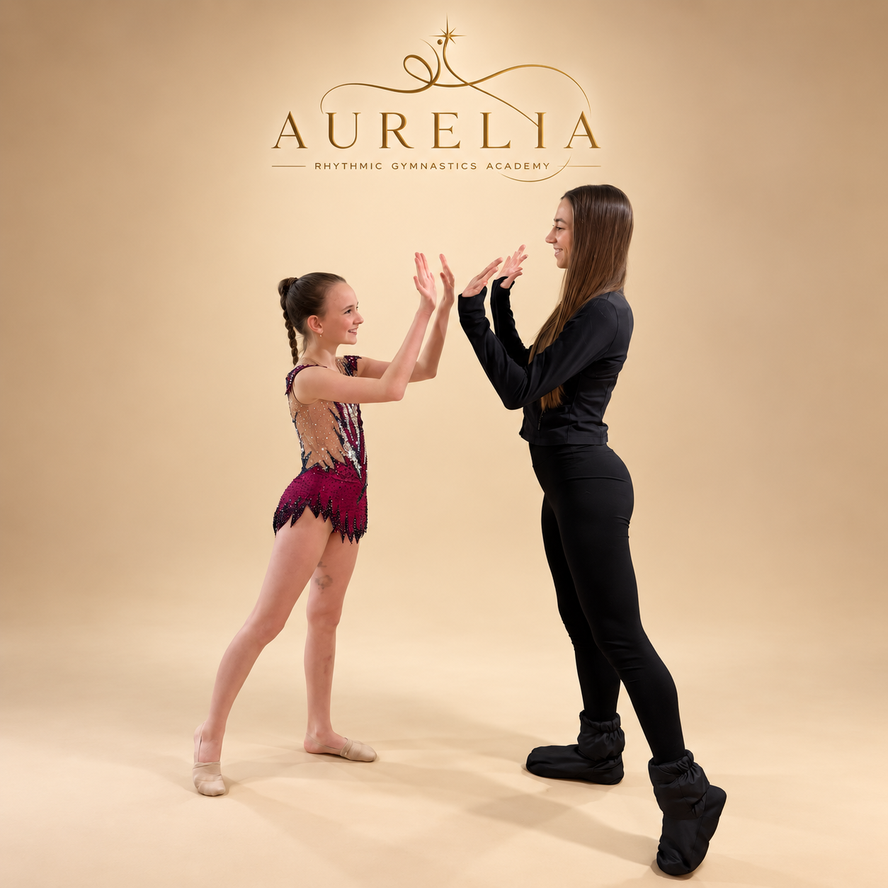 Aurelia gymnast and coach sharing a high-five beneath the Aurelia logo